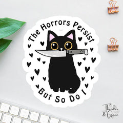 The Horrors Persist But So Do I Sticker, Black Cat With Knife, Funny Cat Sticker, Funny Laptop Decal, Coworker Magnet, Halloween Cat - Cut Vinyl Decal